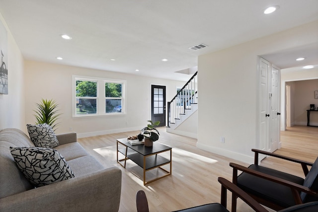 1006 Irene Dr, Mesquite, TX 75149 - living room featuring light wood-style floors, recessed lighting, stairs, and baseboards