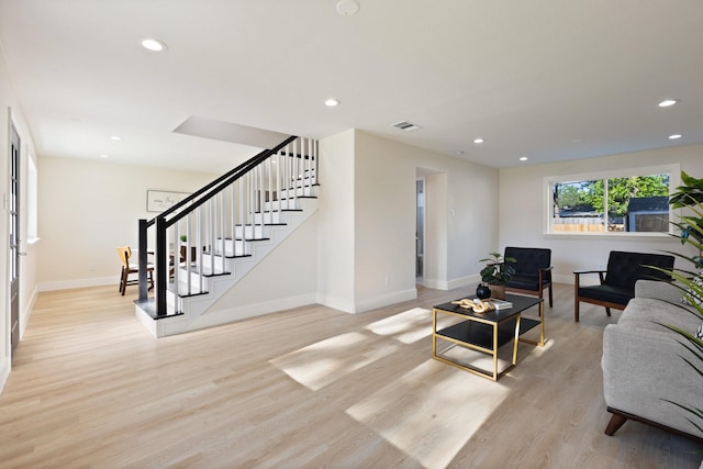 1006 Irene Dr, Mesquite, TX 75149 - living room featuring baseboards, stairs, light wood-style floors, and recessed lighting