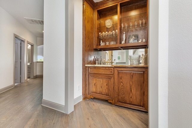 2605 Cherry Sage Dr, Flower Mound, TX 75022 - indoor wet bar with light wood finished floors and baseboards