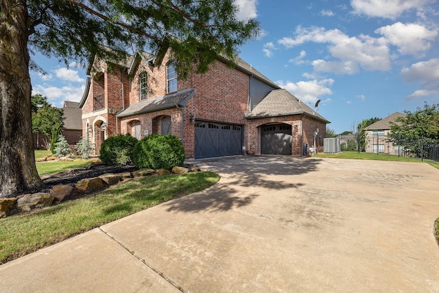 2605 Cherry Sage Dr, Flower Mound, TX 75022 - view of front of home featuring brick siding, fence, driveway, and central air condition unit