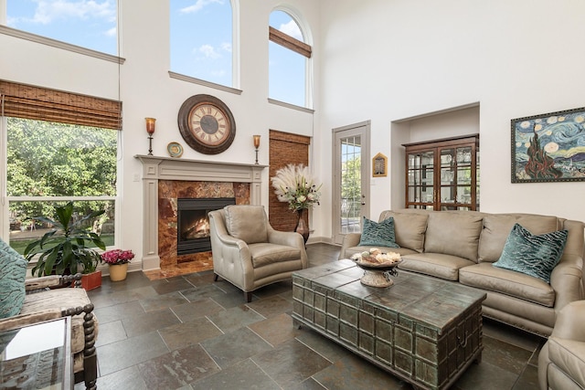 2605 Cherry Sage Dr, Flower Mound, TX 75022 - living area featuring a towering ceiling, a fireplace, and stone tile floors