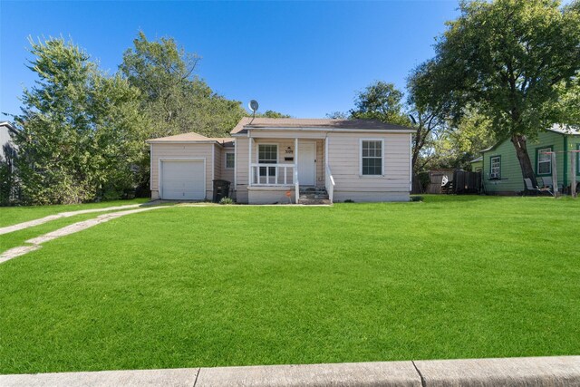 3109 S Wesleyan Dr, Fort Worth, TX 76105 - view of front facade with covered porch, driveway, a front lawn, and a garage