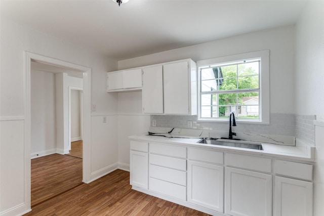 3109 S Wesleyan Dr, Fort Worth, TX 76105 - kitchen with a sink, light wood finished floors, white cabinetry, and light countertops