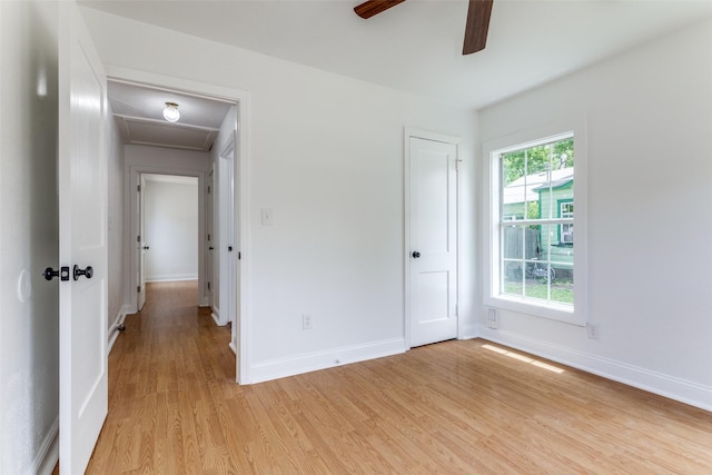 3109 S Wesleyan Dr, Fort Worth, TX 76105 - unfurnished bedroom featuring light wood-style floors, baseboards, attic access, and a ceiling fan