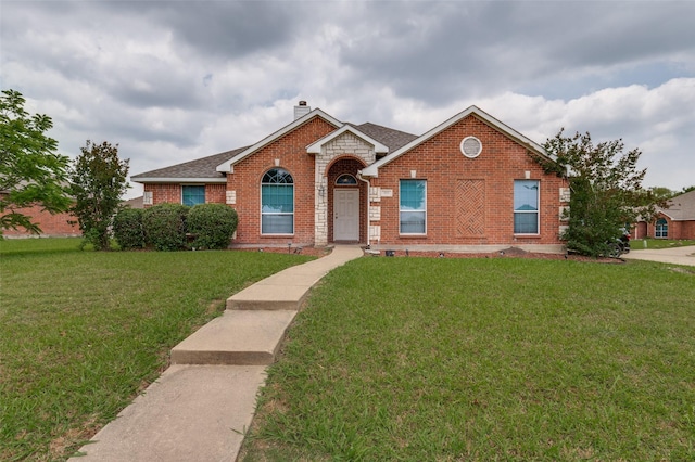 223 Troy Ln, Red Oak, TX 75154 - traditional home with brick siding, a front yard, roof with shingles, and a chimney