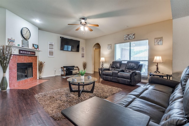 223 Troy Ln, Red Oak, TX 75154 - living area featuring arched walkways, ceiling fan, a fireplace, wood finished floors, and baseboards