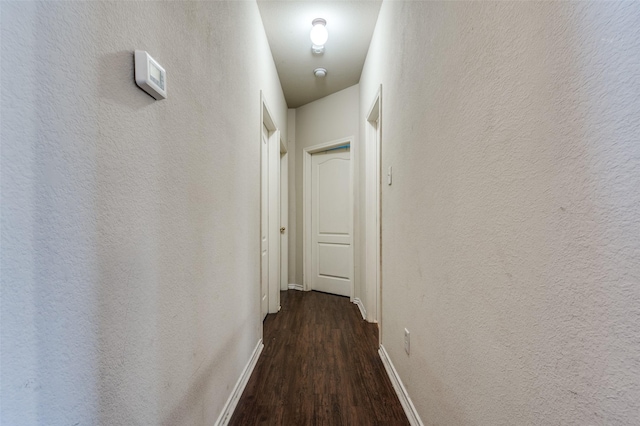 223 Troy Ln, Red Oak, TX 75154 - corridor with dark wood-style floors, baseboards, and a textured wall