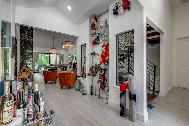 6211 Baymar Ln, Dallas, TX 75252 - hall with stairway, wood tiled floors, high vaulted ceiling, and baseboards