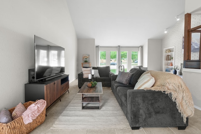 living room with high vaulted ceiling and built in shelves