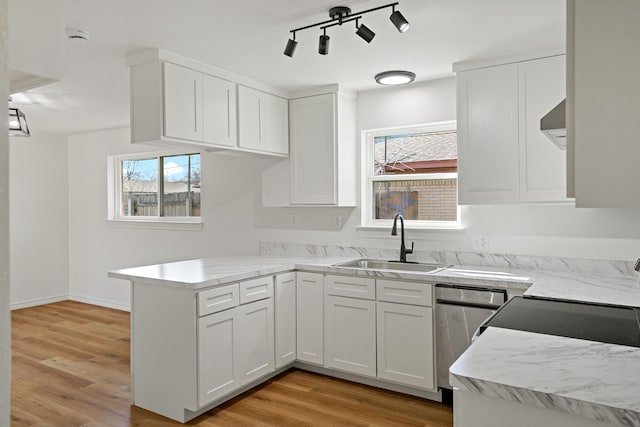 12816/12818 Pandora Dr, Dallas, TX 75238 - kitchen with a sink, a peninsula, white cabinets, stainless steel dishwasher, and light wood-style flooring