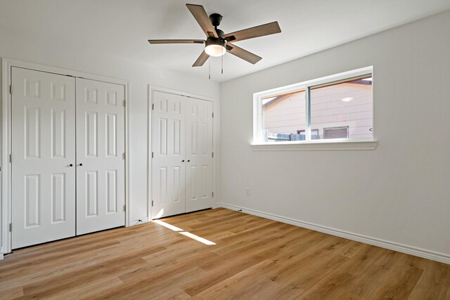 12816/12818 Pandora Dr, Dallas, TX 75238 - unfurnished bedroom with two closets, baseboards, light wood-style floors, and a ceiling fan