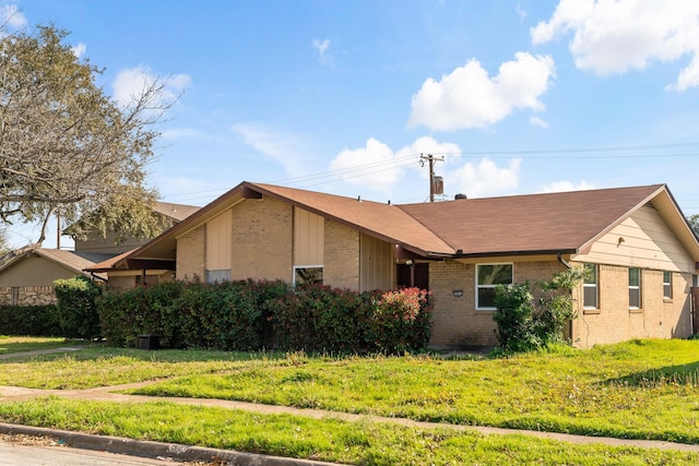12816/12818 Pandora Dr, Dallas, TX 75238 - view of front facade with brick siding, a front yard, and roof with shingles