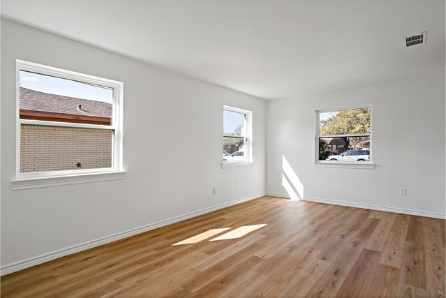 12816/12818 Pandora Dr, Dallas, TX 75238 - spare room featuring light wood-type flooring and baseboards