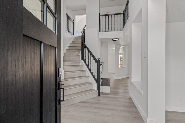 7129 Don Gomez Ln, Garland, TX 75043 - entrance foyer with stairway, baseboards, arched walkways, and wood finished floors
