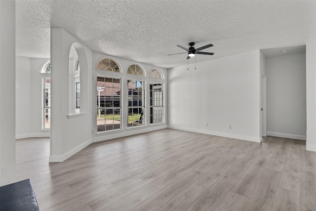 7129 Don Gomez Ln, Garland, TX 75043 - unfurnished living room featuring wood finished floors, a ceiling fan, a textured ceiling, and baseboards
