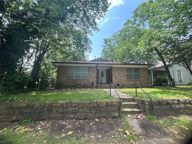 1024 W Chestnut St, Denison, TX 75020 - view of front of home featuring brick siding and a front yard