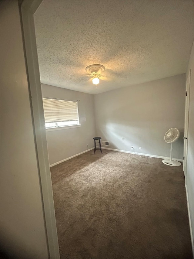1024 W Chestnut St, Denison, TX 75020 - unfurnished room with carpet, baseboards, a textured ceiling, and ceiling fan