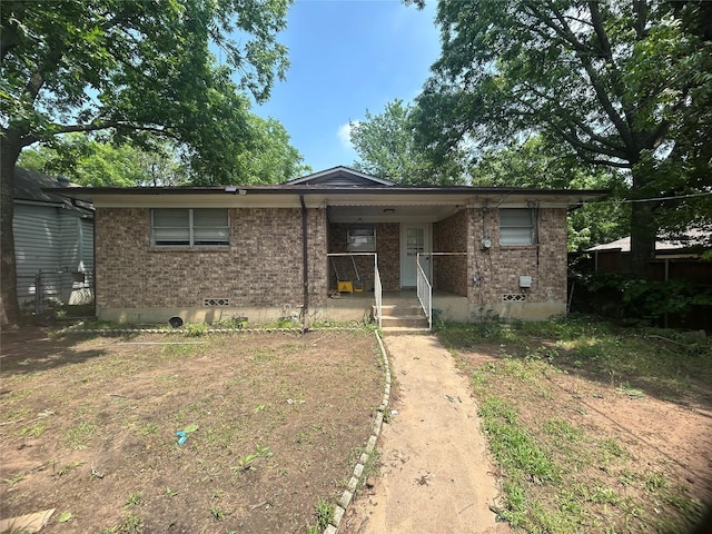 1024 W Chestnut St, Denison, TX 75020 - view of front facade with brick siding, covered porch, and crawl space