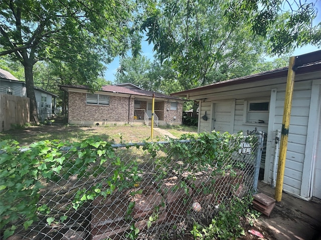 1024 W Chestnut St, Denison, TX 75020 - back of house featuring brick siding