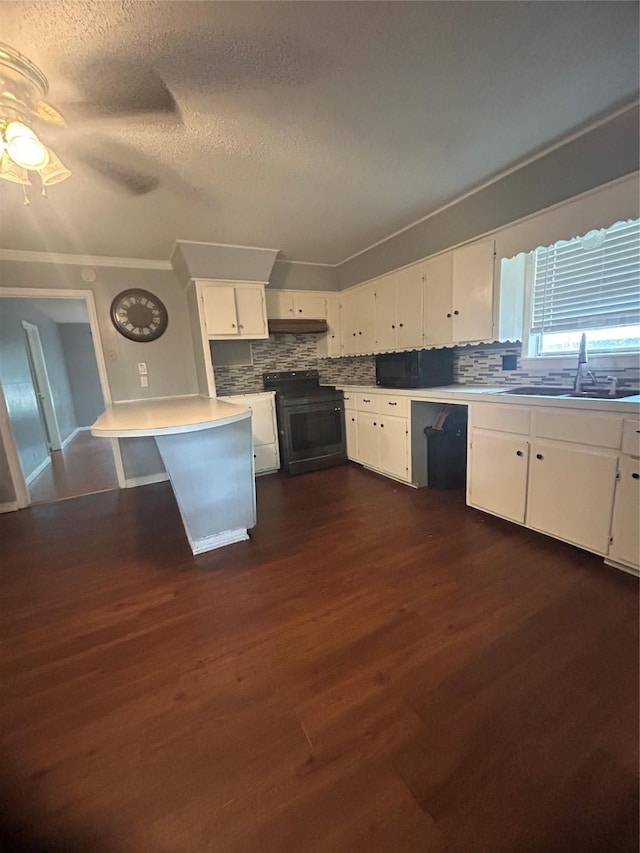 1024 W Chestnut St, Denison, TX 75020 - kitchen featuring a sink, range with electric stovetop, backsplash, white cabinetry, and a textured ceiling