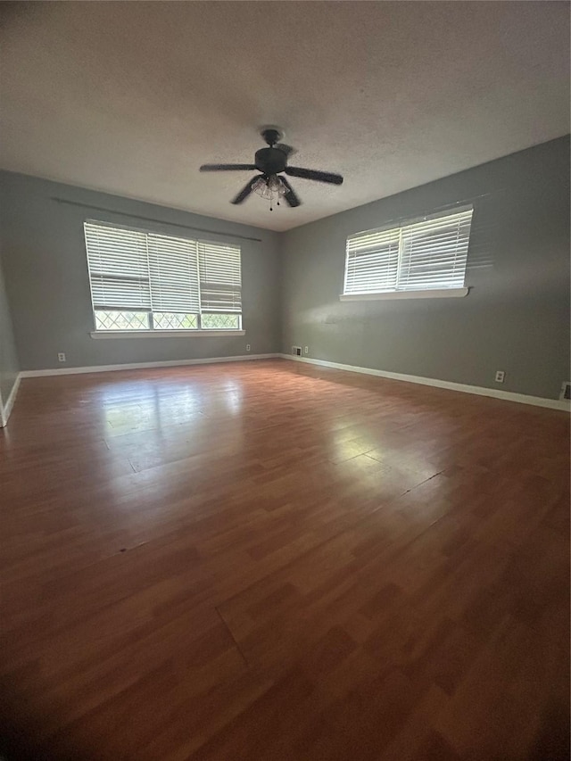 1024 W Chestnut St, Denison, TX 75020 - empty room with a ceiling fan, baseboards, wood finished floors, and a textured ceiling