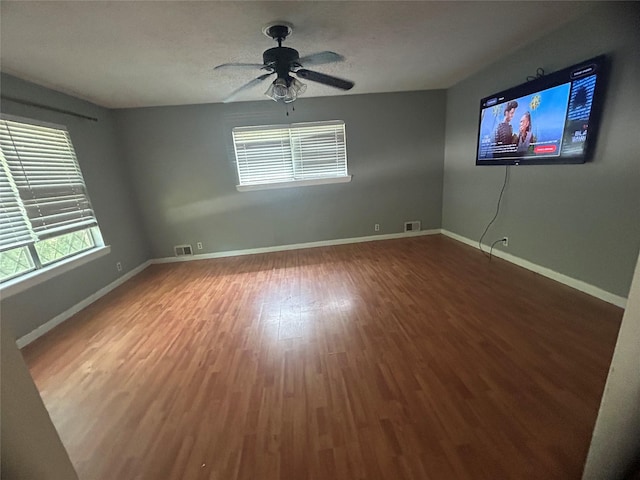 1024 W Chestnut St, Denison, TX 75020 - empty room featuring wood finished floors, baseboards, and ceiling fan