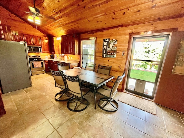 1026 County Road 1744, Chico, TX 76431 - dining room featuring plenty of natural light, vaulted ceiling, wooden ceiling, wooden walls, and light tile patterned flooring