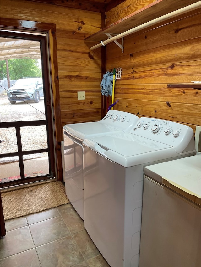 1026 County Road 1744, Chico, TX 76431 - washroom with washing machine and dryer, wood walls, and light tile patterned floors