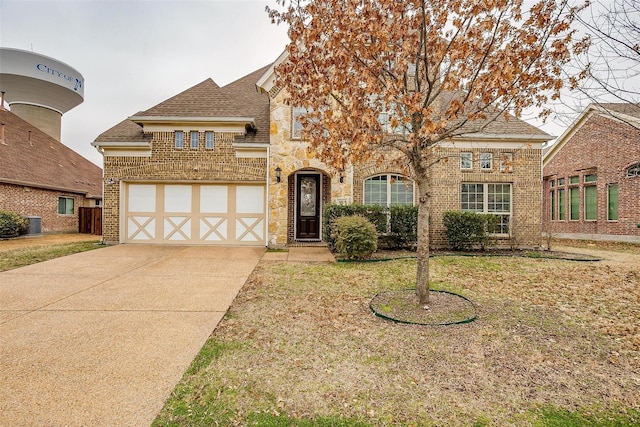 3015 Ruby Dr, Wylie, TX 75098 - view of front of house with brick siding, concrete driveway, a front lawn, a shingled roof, and an attached garage