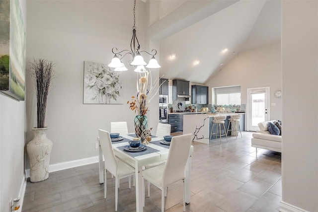 3015 Ruby Dr, Wylie, TX 75098 - dining area featuring high vaulted ceiling, a chandelier, and baseboards