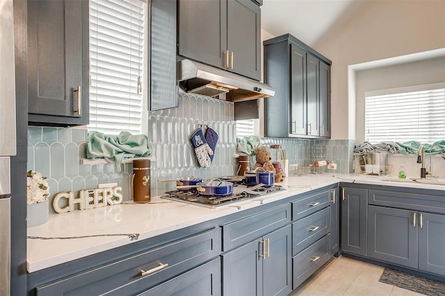 3015 Ruby Dr, Wylie, TX 75098 - kitchen with under cabinet range hood, a sink, healthy amount of natural light, and stainless steel gas cooktop