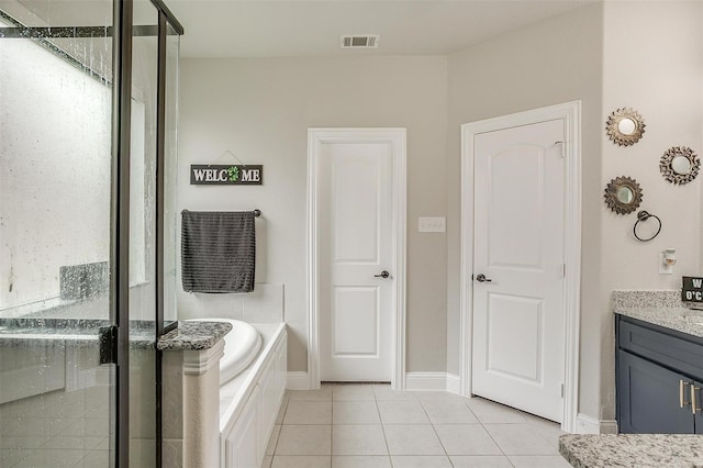 3015 Ruby Dr, Wylie, TX 75098 - full bathroom featuring tile patterned flooring, a garden tub, a stall shower, vanity, and baseboards