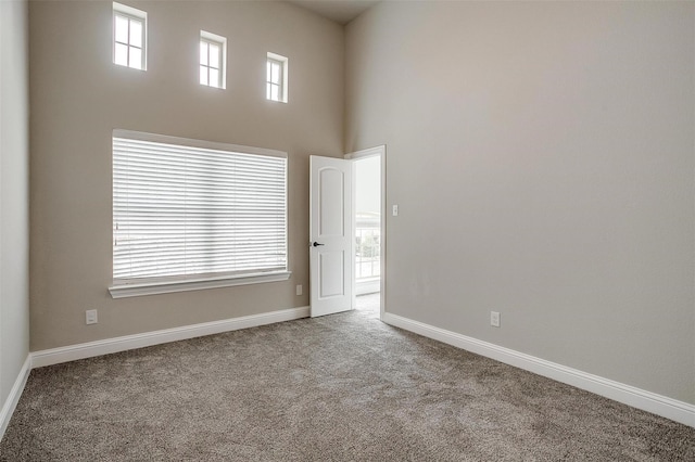 3015 Ruby Dr, Wylie, TX 75098 - carpeted spare room featuring baseboards and a towering ceiling