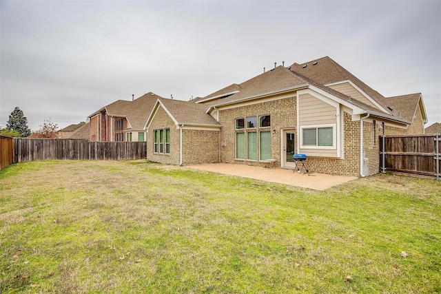 3015 Ruby Dr, Wylie, TX 75098 - back of property with brick siding, a patio area, and roof with shingles
