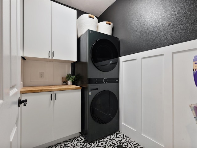 1505 Taylor Ln, Mckinney, TX 75071 - laundry area with estacked washer and dryer, cabinet space, and tile patterned floors