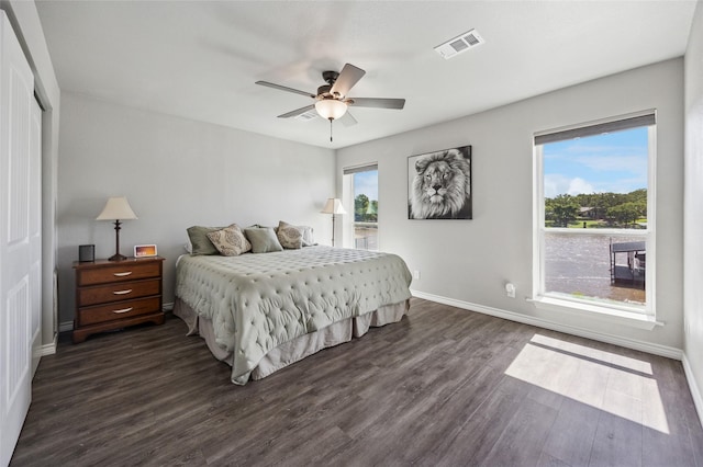563 Country Club Rd, Bowie, TX 76230 - bedroom with dark wood-type flooring, baseboards, ceiling fan, and a closet