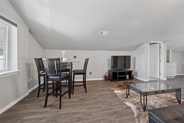 563 Country Club Rd, Bowie, TX 76230 - dining room with lofted ceiling, baseboards, and wood finished floors
