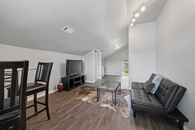 563 Country Club Rd, Bowie, TX 76230 - living area with vaulted ceiling, dark wood finished floors, and baseboards