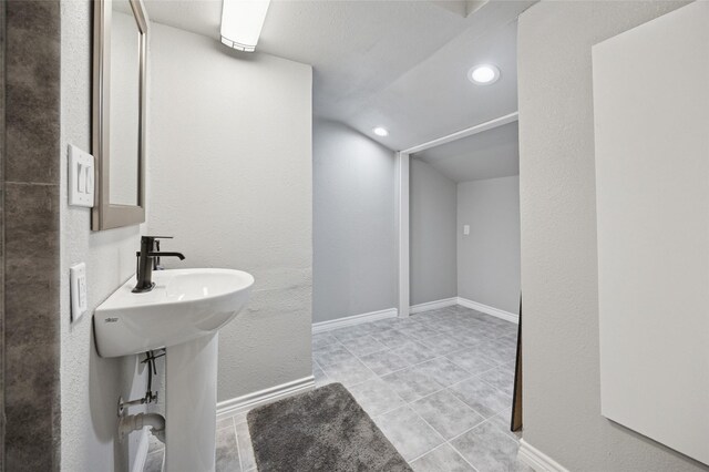 563 Country Club Rd, Bowie, TX 76230 - bathroom with lofted ceiling, recessed lighting, tile patterned floors, and baseboards