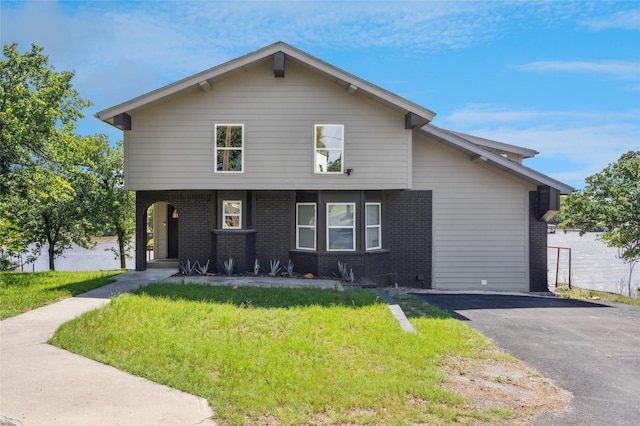 563 Country Club Rd, Bowie, TX 76230 - view of front of home featuring a front lawn, brick siding, and asphalt driveway