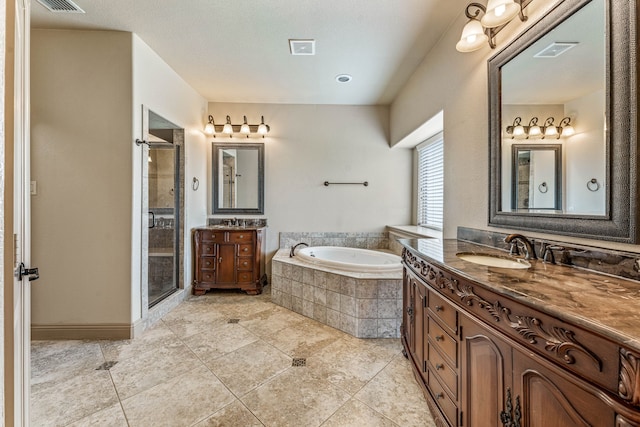 10601 San Simeon Ln, Fort Worth, TX 76179 - full bathroom featuring a garden tub, two vanities, a shower stall, and tile patterned floors