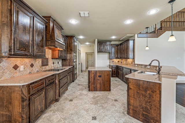 10601 San Simeon Ln, Fort Worth, TX 76179 - kitchen featuring a sink, dark brown cabinets, light stone counters, black electric cooktop, and a peninsula