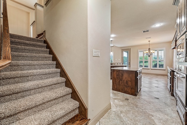 10601 San Simeon Ln, Fort Worth, TX 76179 - stairs with a chandelier, baseboards, tile patterned flooring, recessed lighting, and a textured wall