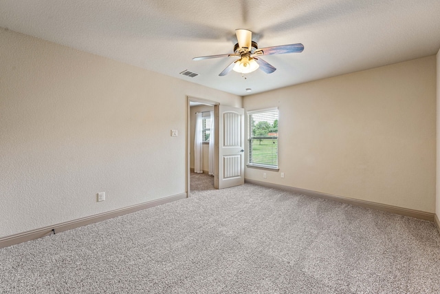 10601 San Simeon Ln, Fort Worth, TX 76179 - unfurnished room featuring light colored carpet, a ceiling fan, baseboards, and a textured ceiling