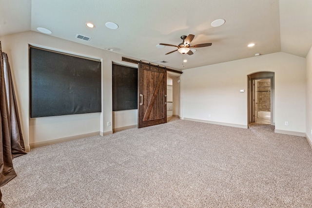10601 San Simeon Ln, Fort Worth, TX 76179 - unfurnished bedroom featuring vaulted ceiling, carpet flooring, baseboards, arched walkways, and a barn door