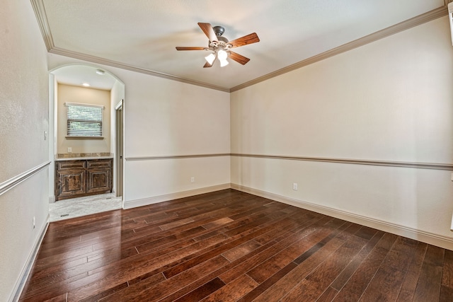 10601 San Simeon Ln, Fort Worth, TX 76179 - empty room featuring a ceiling fan, dark wood-style floors, arched walkways, baseboards, and crown molding