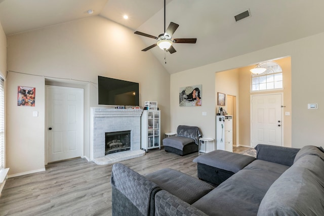 4632 Angelina Way, Fort Worth, TX 76137 - living room featuring high vaulted ceiling, a ceiling fan, light wood-type flooring, a brick fireplace, and baseboards