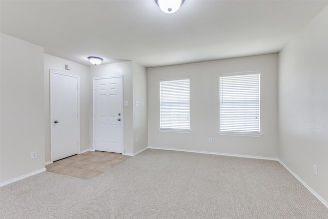 2101 Laughlin Rd, Fort Worth, TX 76177 - empty room with light carpet, baseboards, and light tile patterned floors