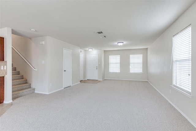 2101 Laughlin Rd, Fort Worth, TX 76177 - unfurnished living room featuring light carpet, stairway, and baseboards