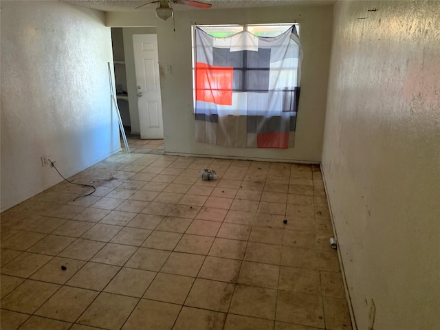 1317 W Bruton Rd, Mesquite, TX 75149 - empty room featuring ceiling fan and light tile patterned floors